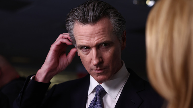 Gavin Newsom touching his ear