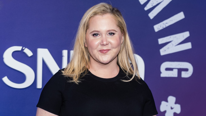 Amy Schumer on red carpet wearing black outfit