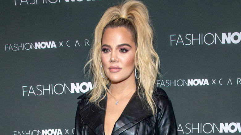 Khloé Kardashian on red carpet in black leather jacket