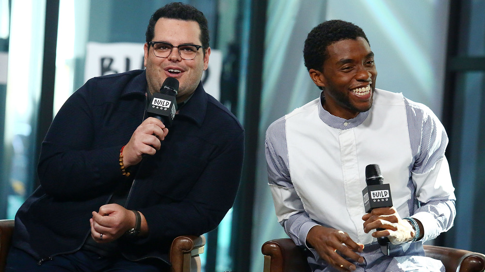 Josh Gad and Chadwick Boseman smiling during interview