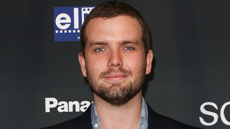 Austin Swift in front of a black background