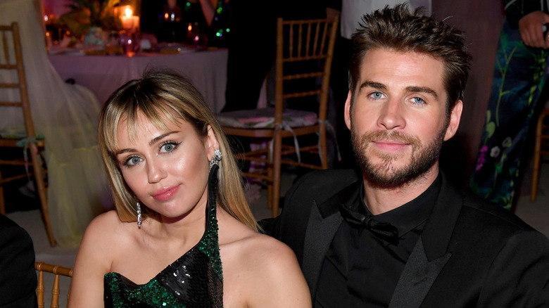 Miley Cyrus posing with Liam Hemsworth
