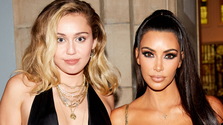 Miley Cyrus posing with Kim Kardashian