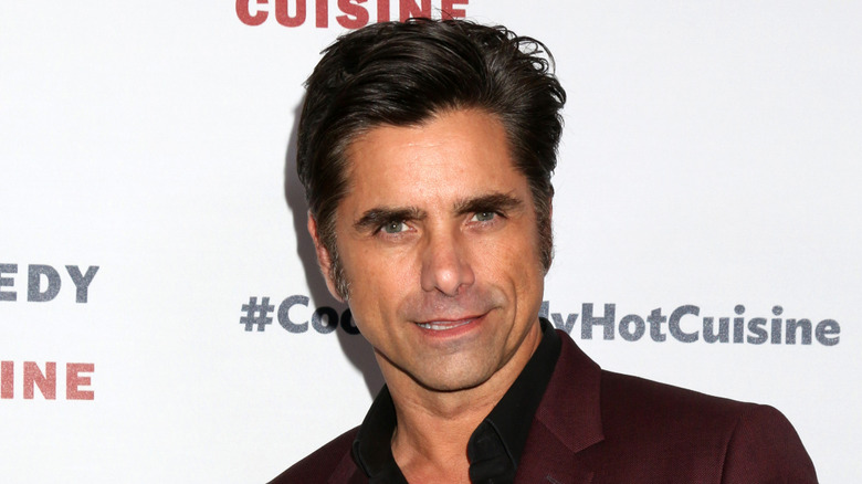 John Stamos sneering