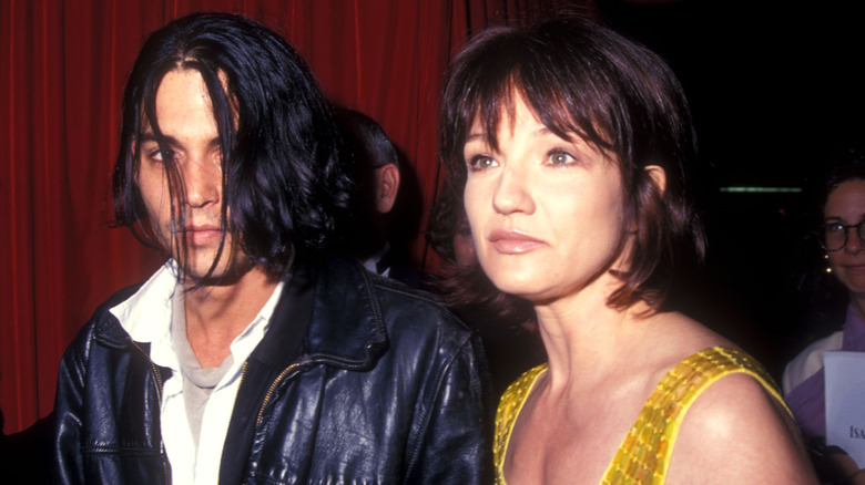 Johnny Depp and Ellen Barkin attending an event