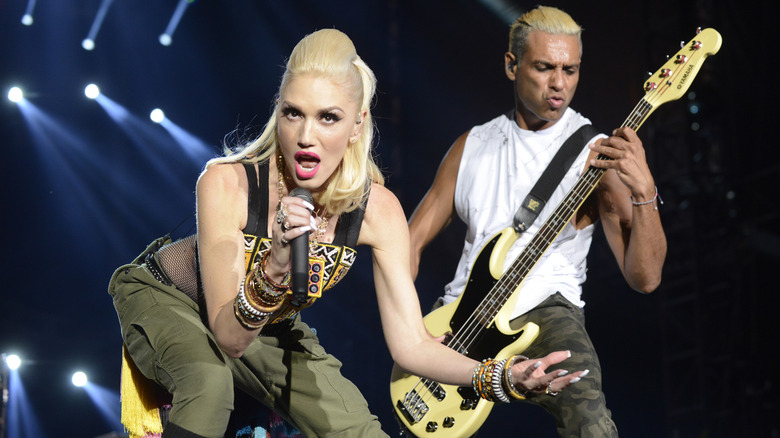 Gwen Stefani and Tony Kanal performing on stage