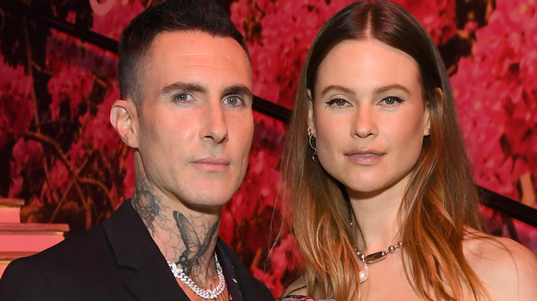 Behati Prinsloo and Adam Levine posing together