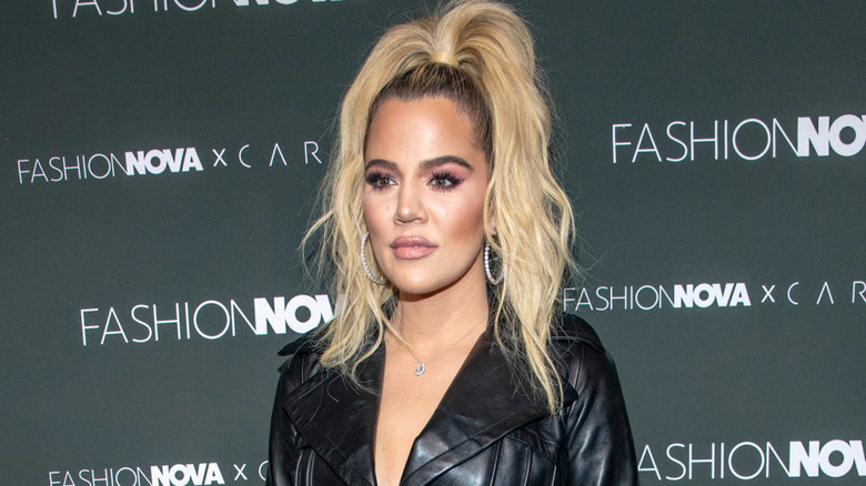 Khloé Kardashian on red carpet in black leather jacket