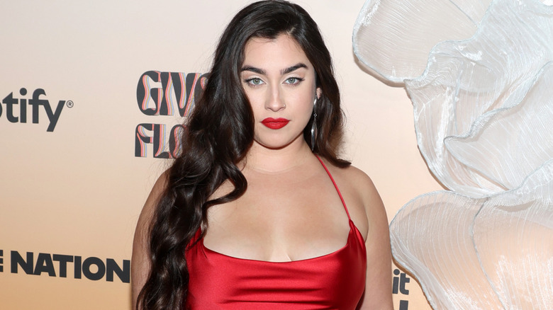 Lauren Jauregui on red carpet wearing red dress