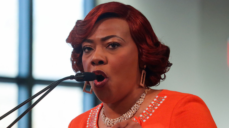 Bernice King giving speech in orange blouse