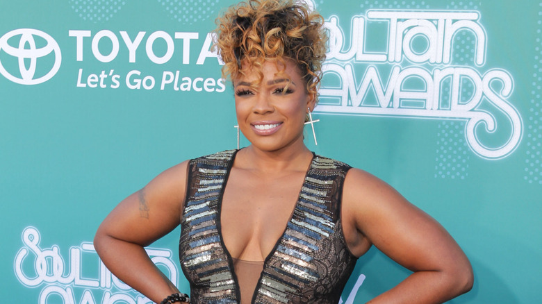 Syleena Johnson on red carpet with sparkle dress