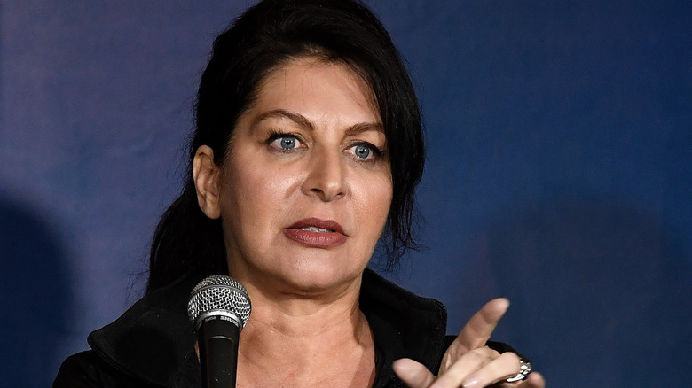 Tammy Pescatelli on stage with microphone