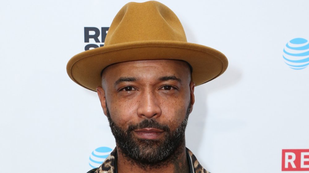 Joe Budden in a brown fedora