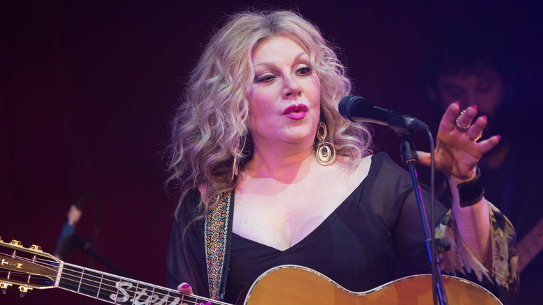 Stella Parton with guitar during a concert