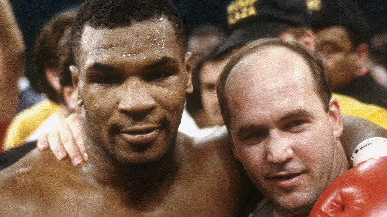 Mike Tyson and Kevin Rooney, arm in arm