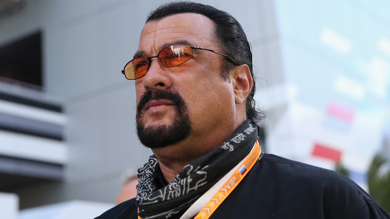 Steven Seagal brooding, wearing orange-tinted glasses and a bandana