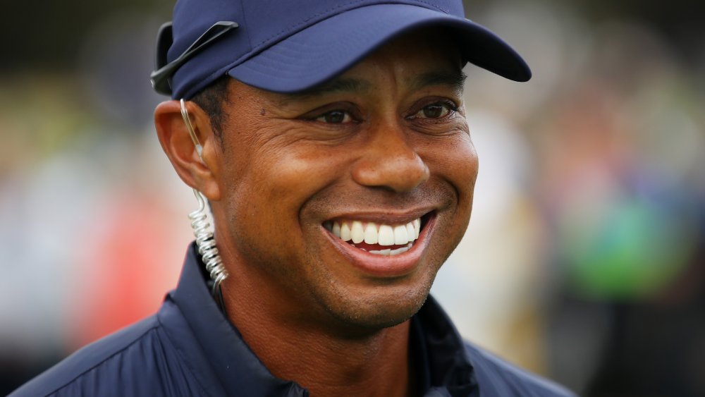 Tiger Woods smiling on the golf course