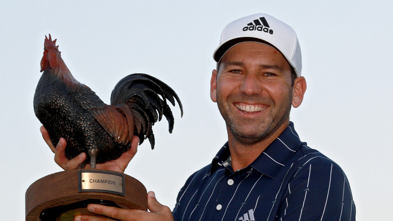 Sergia Garcia smilling and holding a chicken trophy