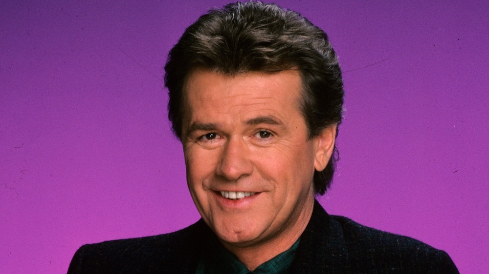 John Reilly smiling and posing