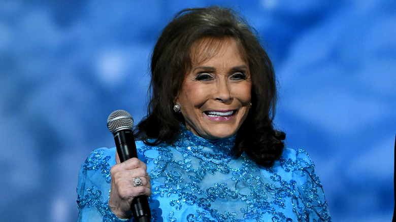 Loretta Lynn with a microphone