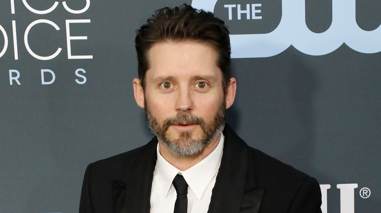 Brandon Blackstock posing in black suit and tie
