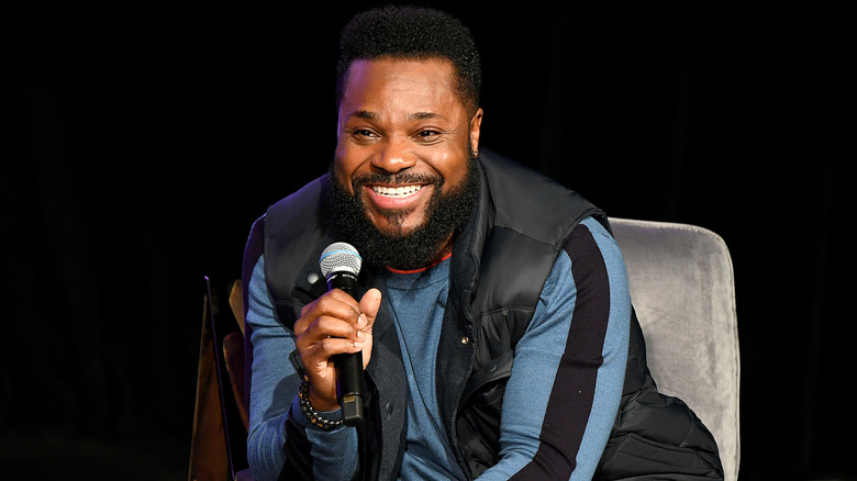 Malcolm-Jamal Warner speaking on stage.
