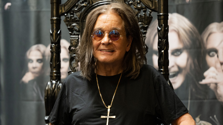 Ozzy Osbourne posing at an album signing.