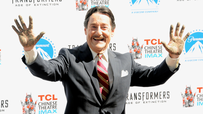 Peter Cullen posing at the Optimus Prime hand and footprint ceremony in 2014