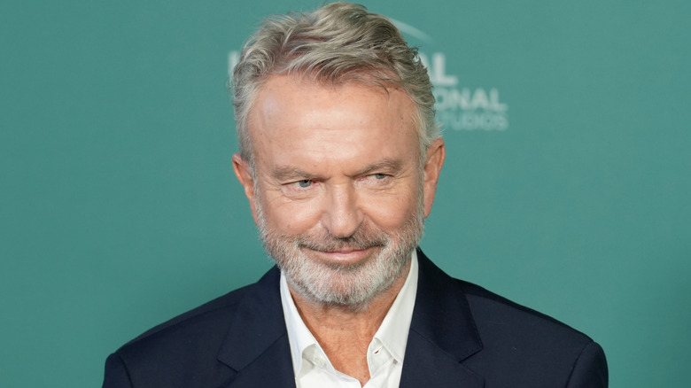 Sam Neill posing on the red carpet
