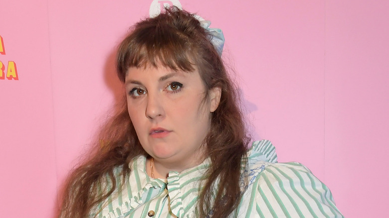 Lena Dunham posing with pink background