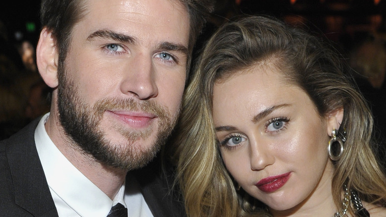 Liam Hemsworth and Miley Cyrus posing