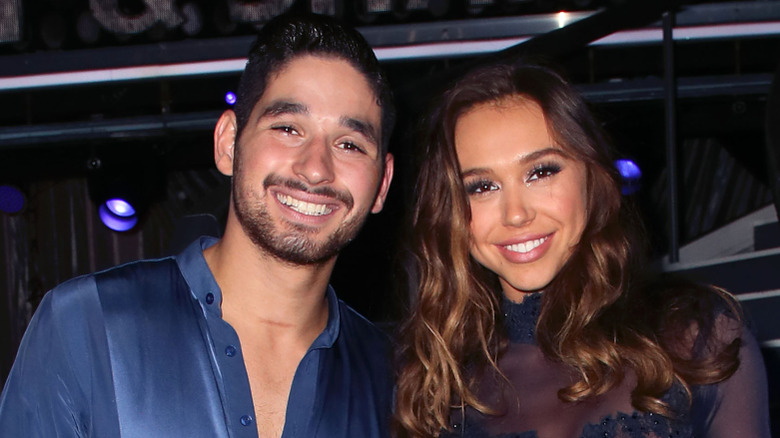 Alan Bersten and Alexis Ren smiling