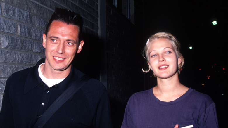 Drew Barrymore and Jeremy Thomas walking