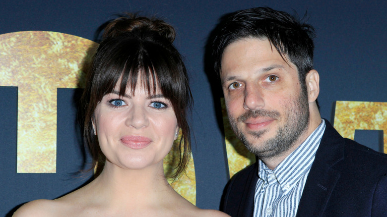 Casey Wilson and David Caspe posing at an event