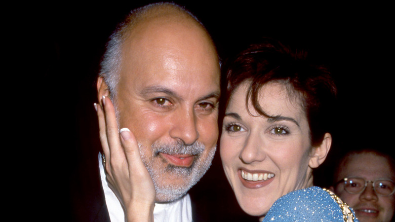 Céline Dion smiling and embracing late husband René Angélil