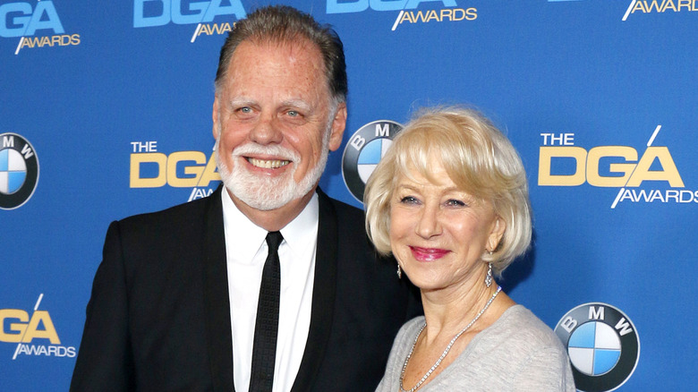 Taylor Hackford and Helen Mirren smiling on a red carpet