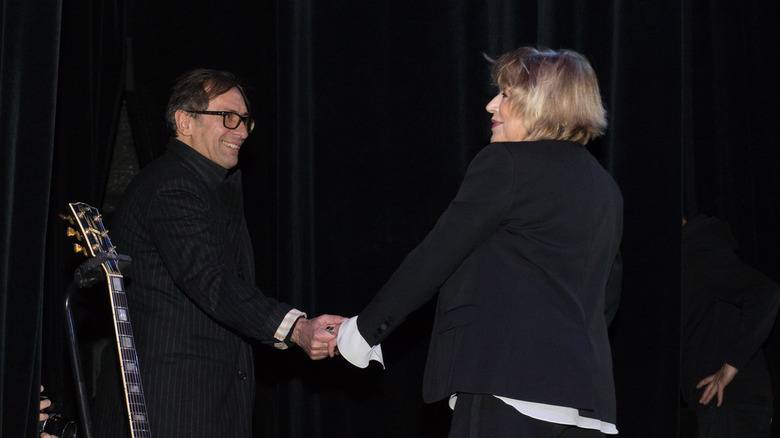 Marianne Faithfull and François Ravard holding hands