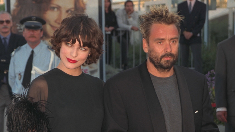 Milla Jovovich with Luc Besson walking on the red carpet