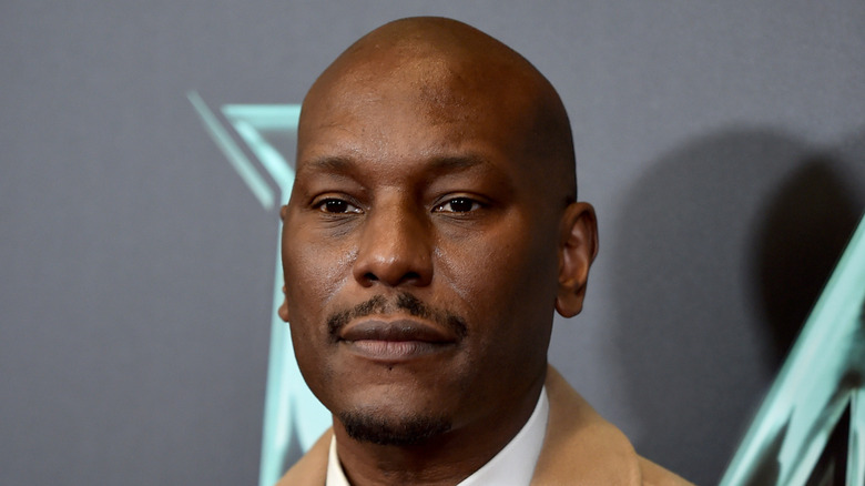 Tyrese wearing a brown jacket