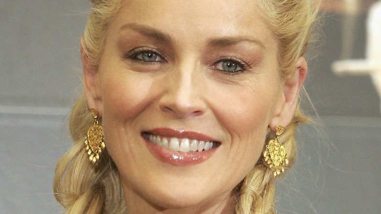 Sharon Stone wearing two French braid ponytails