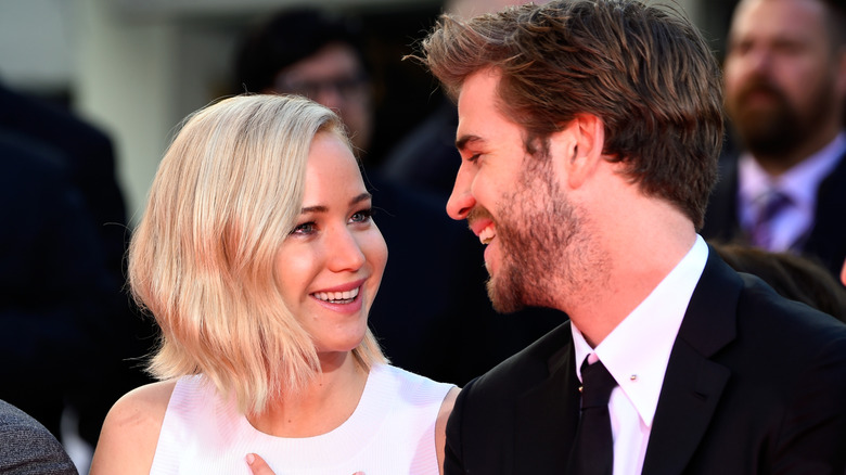 Jennifer Lawrence smiling at Liam Hemsworth at "The Hunger Games: Mockingjay - Part 2" Hand and Footprint Ceremony