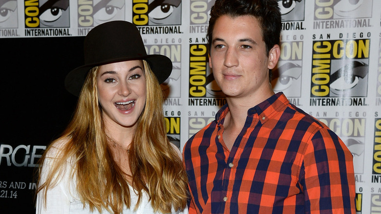 Shailene Woodley with mouth open beside Miles Teller at Comic-Con International 2013