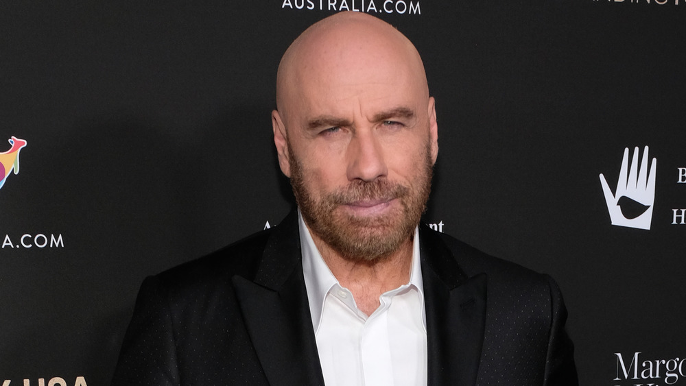 Bald John Travolta looking at camera
