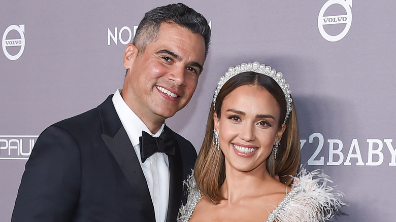 Cash Warren smiling, Jessica Alba wearing a pearl crown