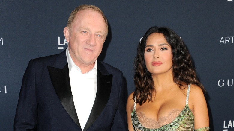 François-Henri Pinault smiling, Salma Hayek with curly hair
