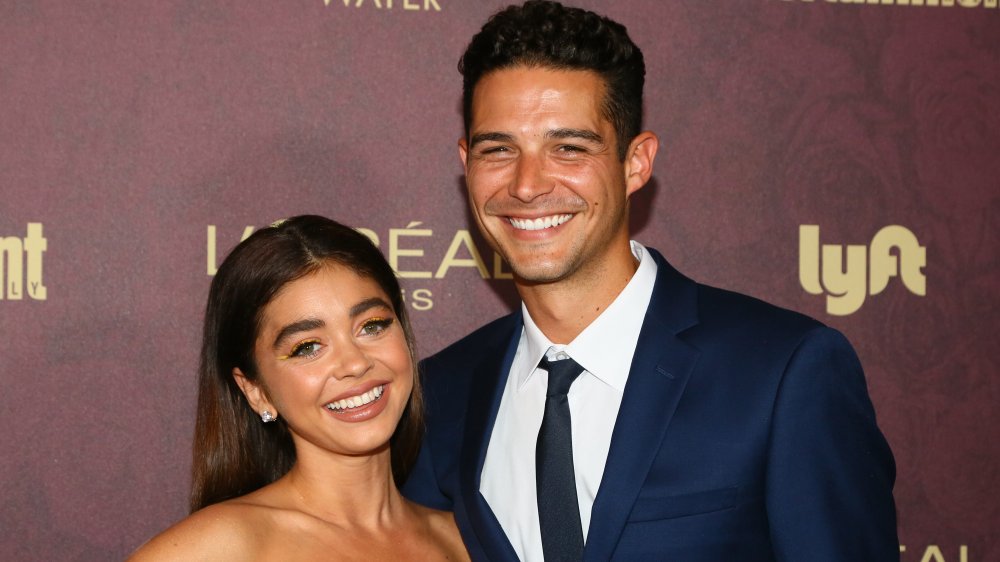 Sarah Hyland and Wells Adams posing at an event