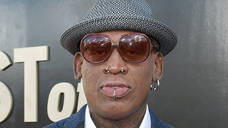 Dennis Rodman wearing a blue suit