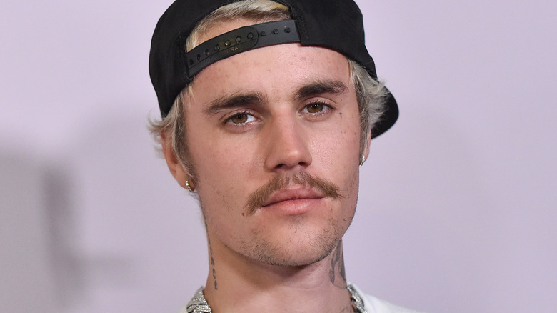 Justin Bieber wearing a cap backwards 
