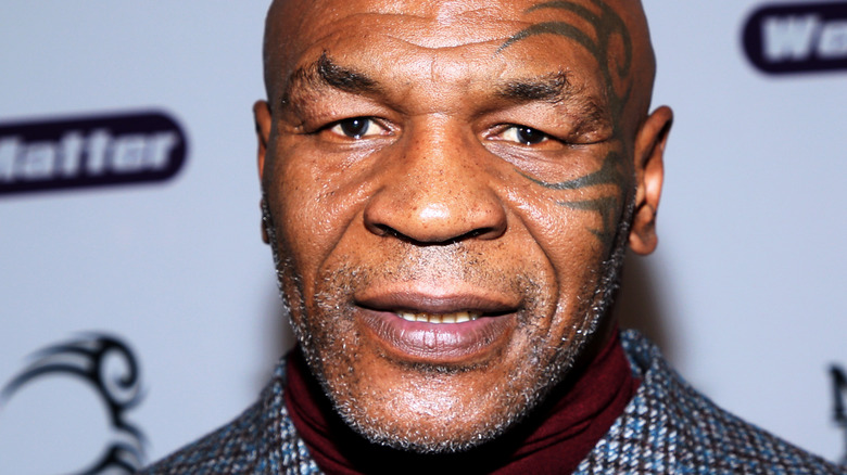 Mike Tyson wearing a plaid jacket 
