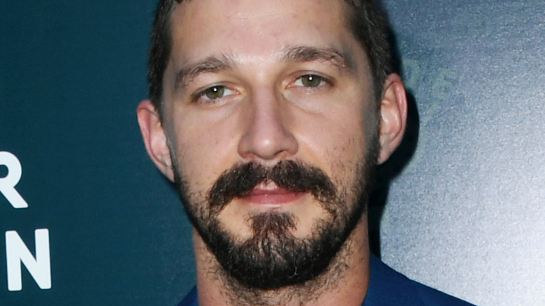 Shia LaBeou wearing a blue suit